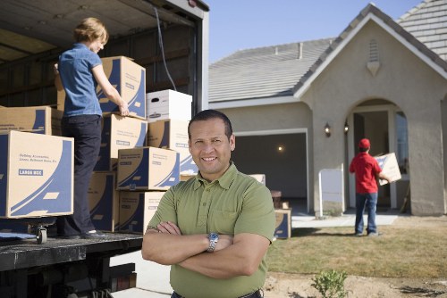 Moving crew carrying furniture through a property entrance