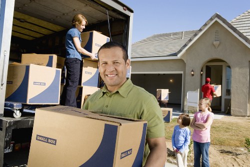 Professional movers loading furniture for transport